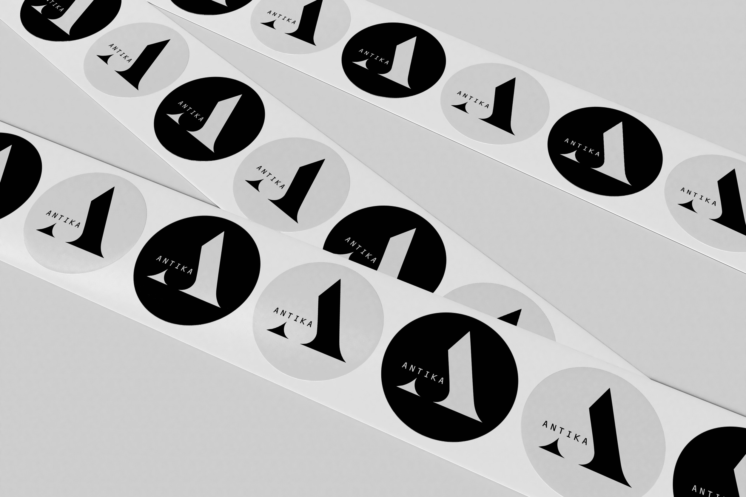 A roll of round black and white stickers featuring the letter A prominently displayed.