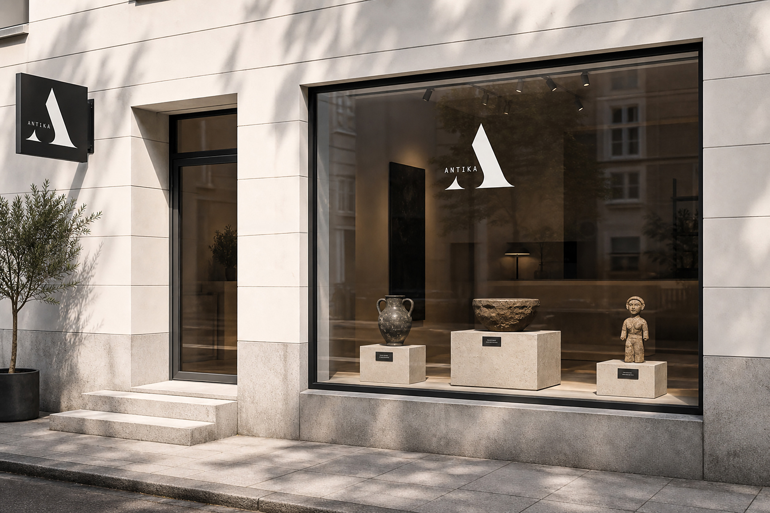 Exterior view of ANTIKA Curated Objects Store showcasing a statue in the window, inviting customers to explore inside.