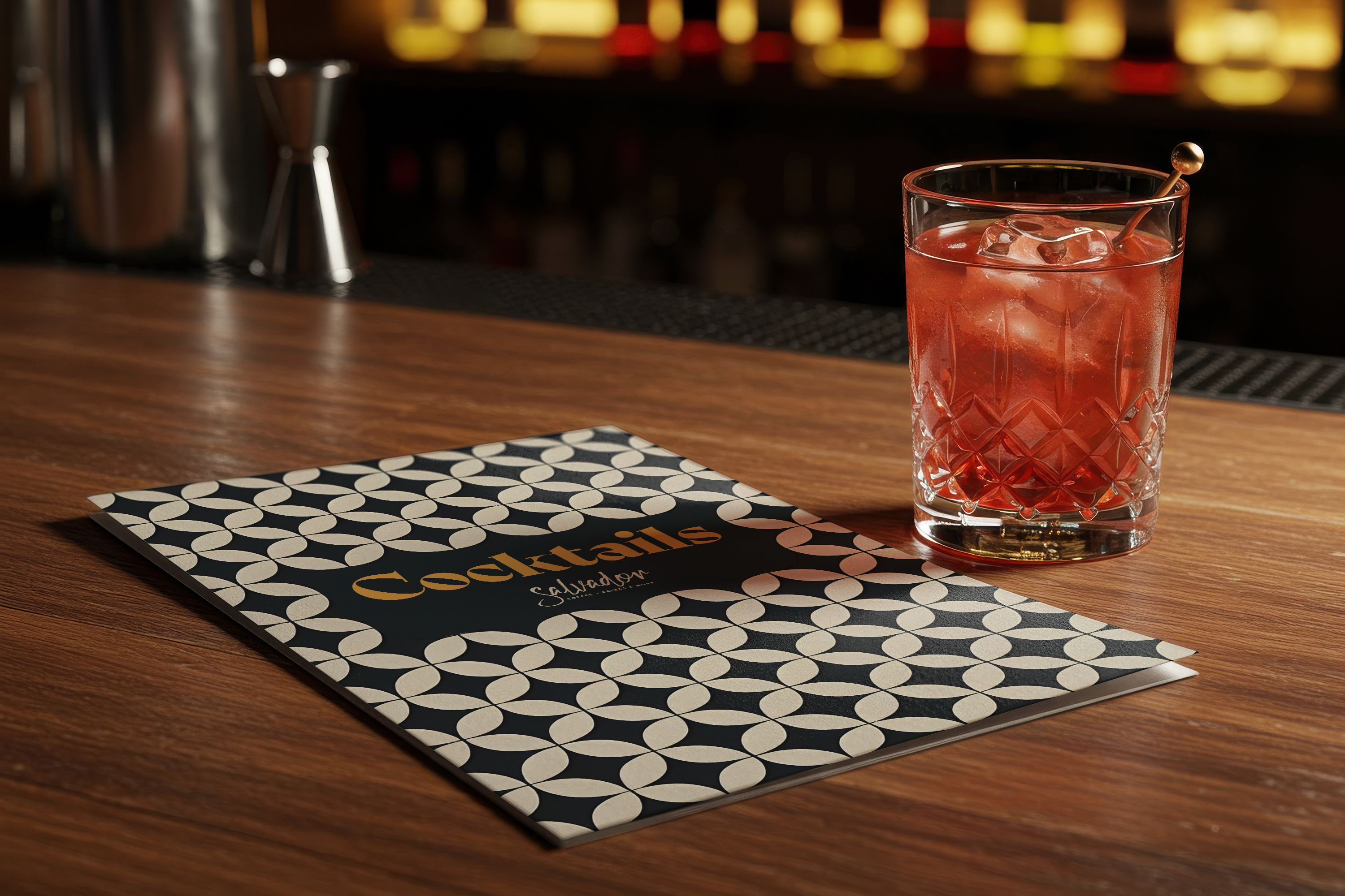 Catalogue of Salvador Bar Athens next to a cherry cocktail.