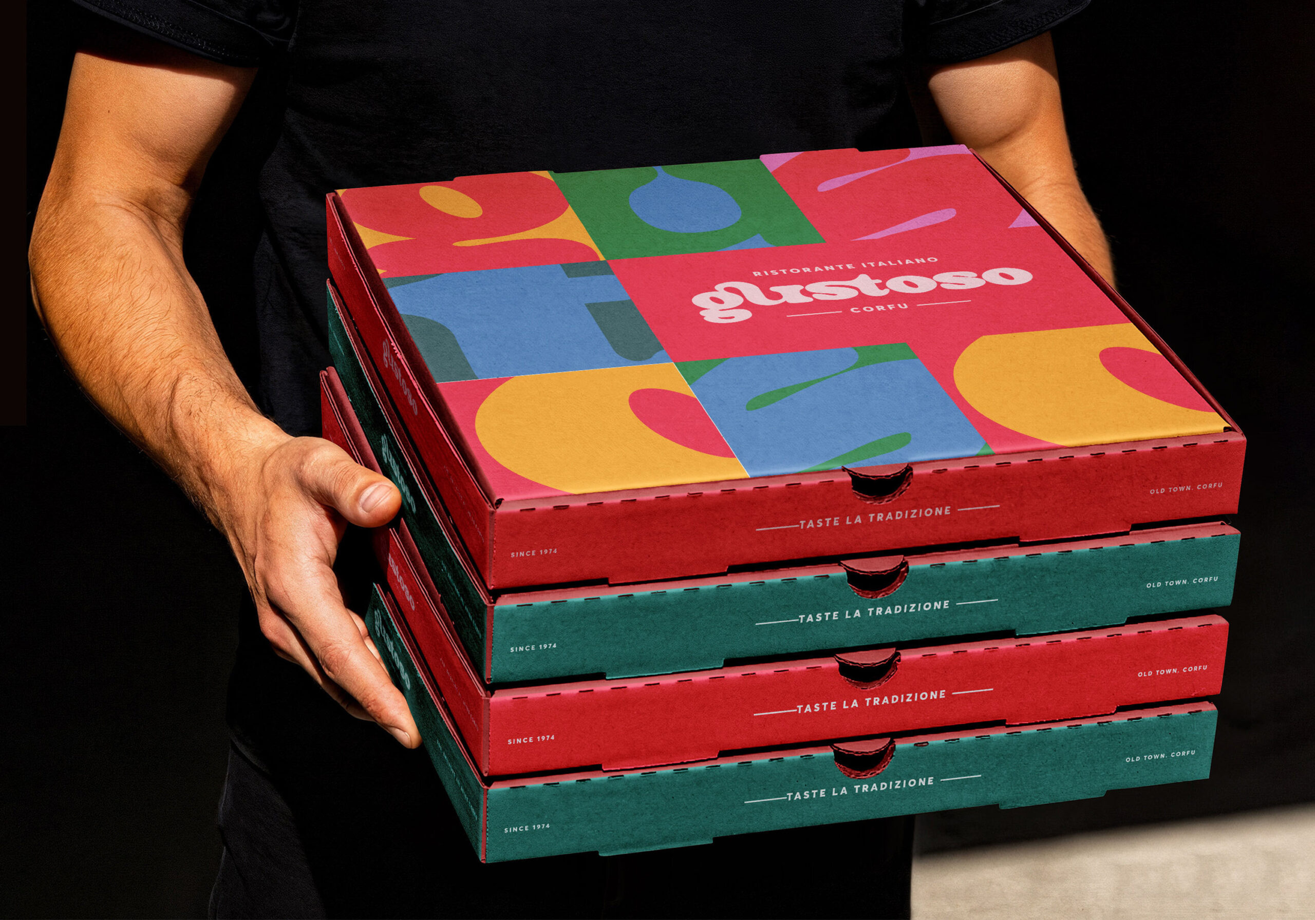 A man displays three pizza boxes, indicating a selection of tasty pizzas for a gathering or meal.