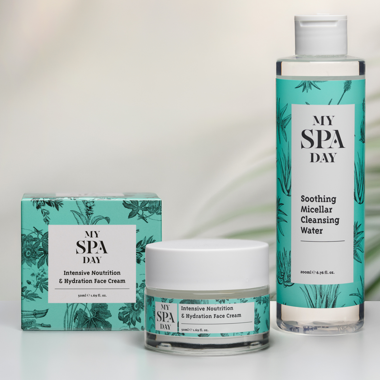 A collection of spa day products arranged on a white background, featuring essential oils, candles, and soft towels.