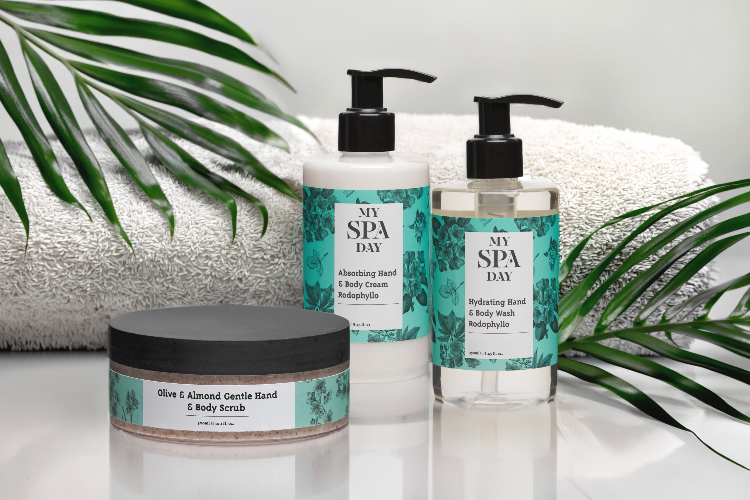 A luxurious spa gift set with a body scrub, body lotion, and body wash displayed on a serene background.